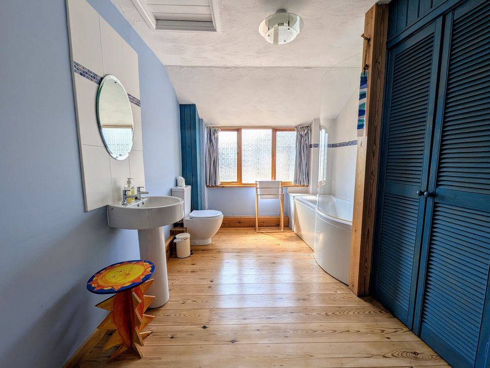 A bathroom with a sink and bathtub at The Old Barn near St Ives Rustic Charm Space, Lelant