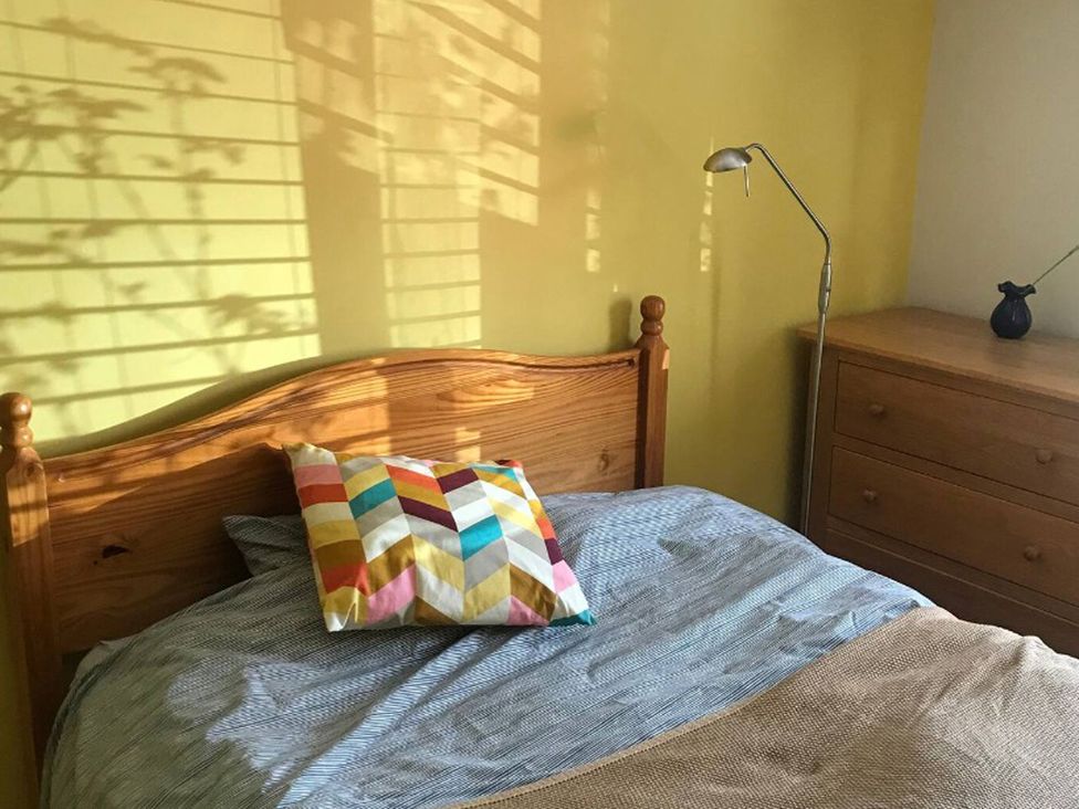 A bedroom with a bed and lamp at The Old Barn near St Ives Rustic Charm Space Lelant