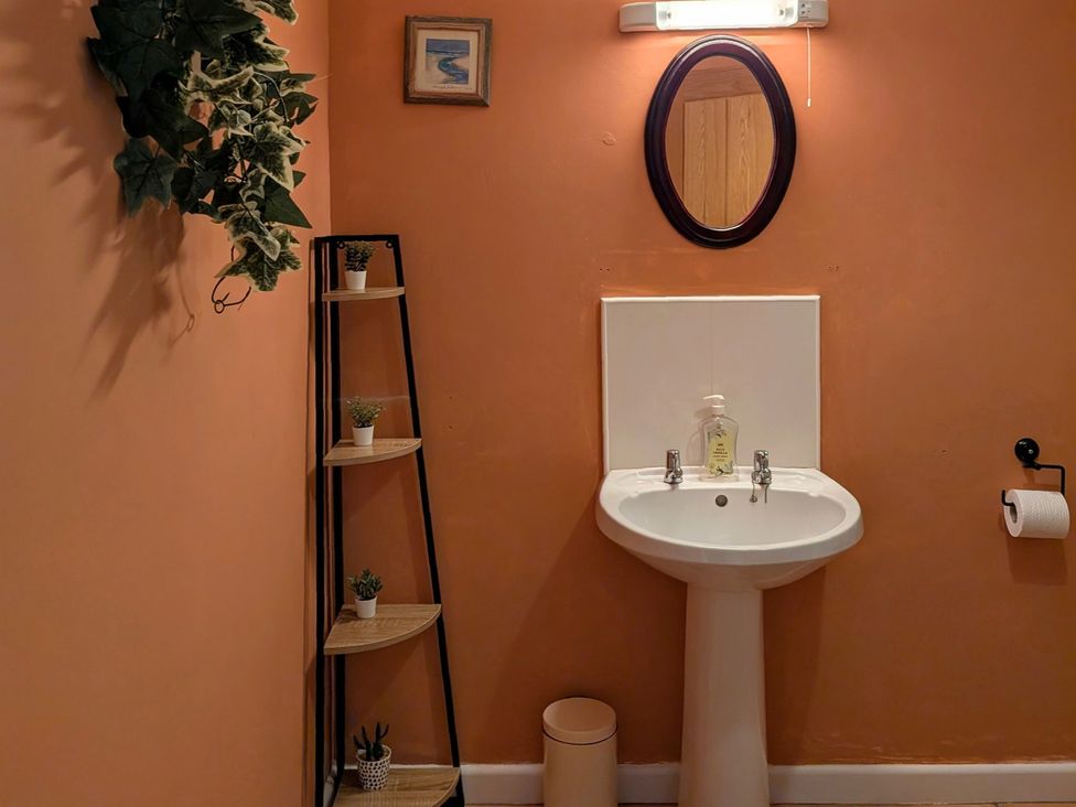 A bathroom with a sink and mirror at The Old Barn near St Ives Rustic Charm Space Lelant