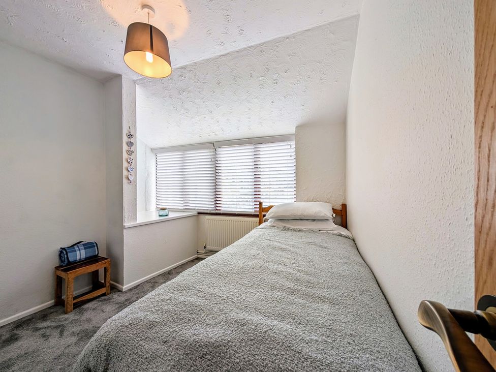 A bedroom with a bed and window at The Old Barn near St Ives Rustic Charm Space Lelant