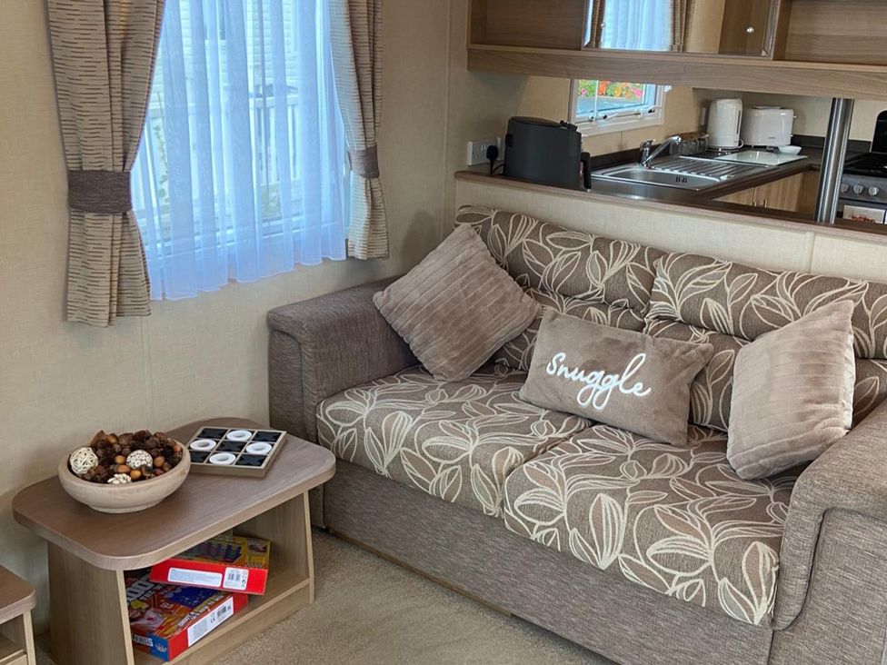 A living room with a sofa and coffee table at a property