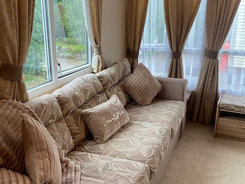 A living room with a sofa and cushions at an unspecified location