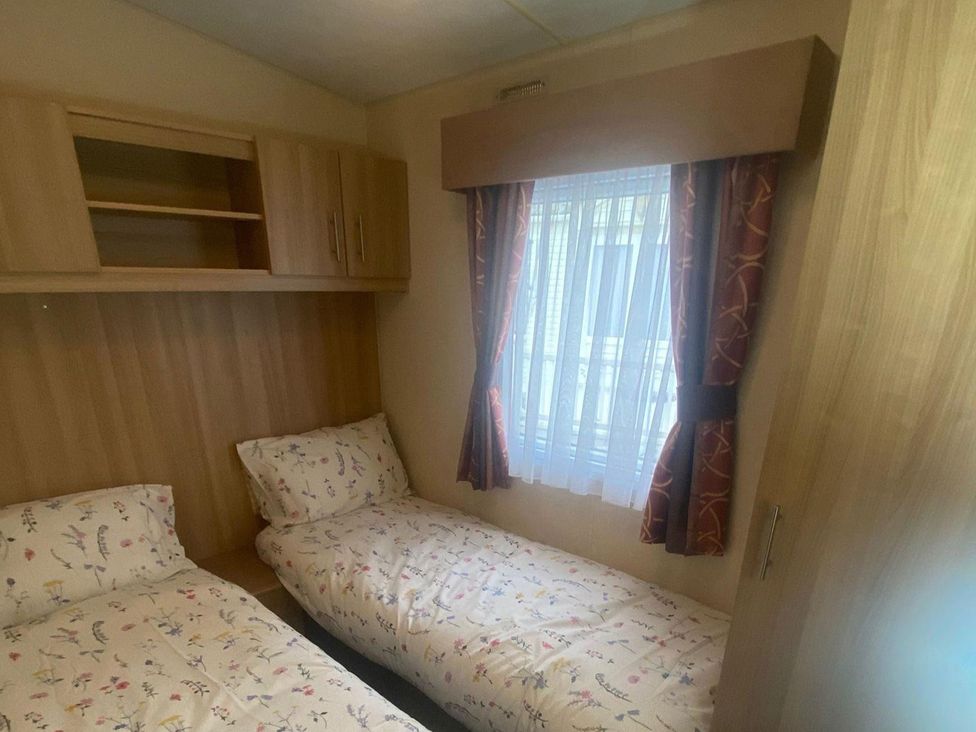 A bedroom with two beds and a window at the property