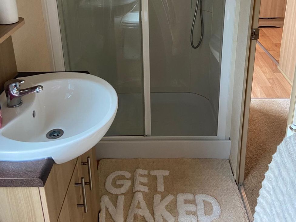 A bathroom with a sink and shower at the property