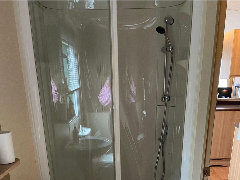 A shower enclosure with a toilet and sink visible in the bathroom at the property