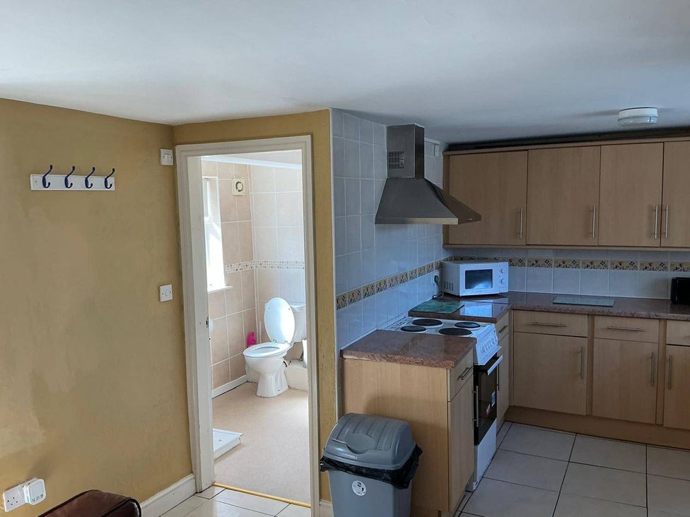A kitchen with stove and microwave at the property in the location 