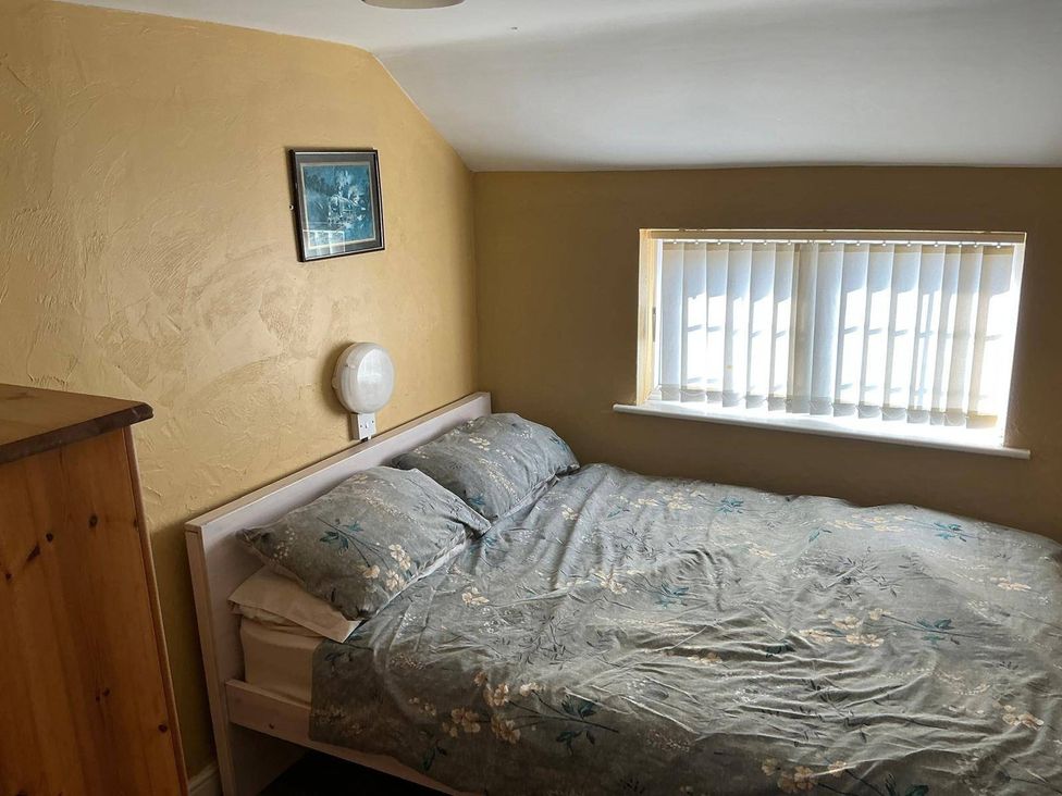 A bedroom with a bed and window at The Old Barn in Manchester
