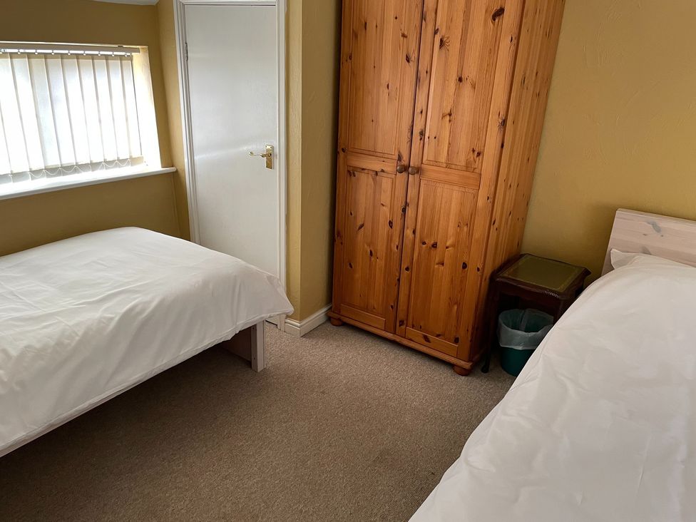 A bedroom with two beds and a wardrobe at 