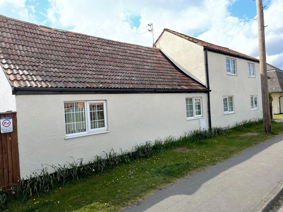 A house with windows and grass in front at unspecified location