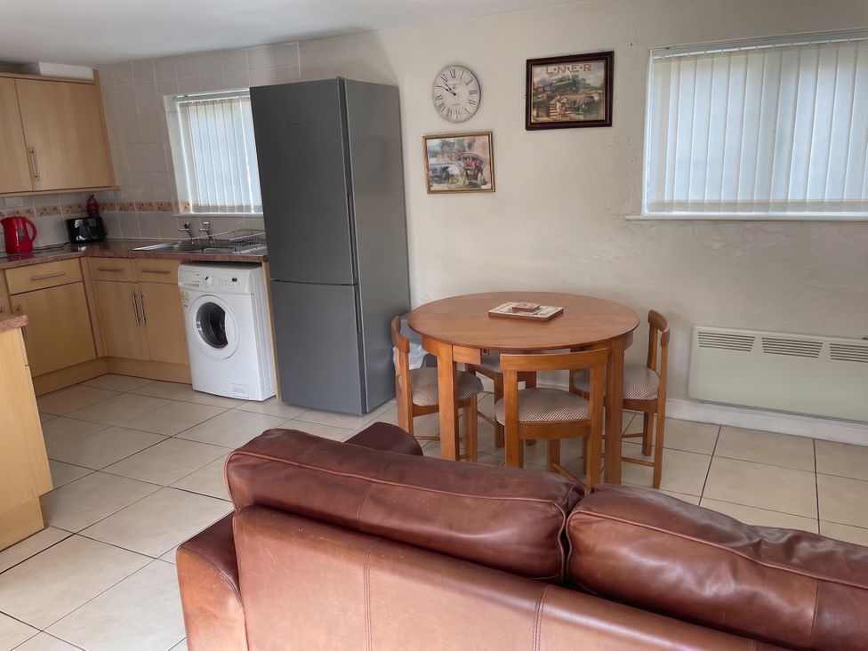 A kitchen with a refrigerator and dining table at Sweetpea Cottage Sleeps 5 Parking Pets Ok Louth