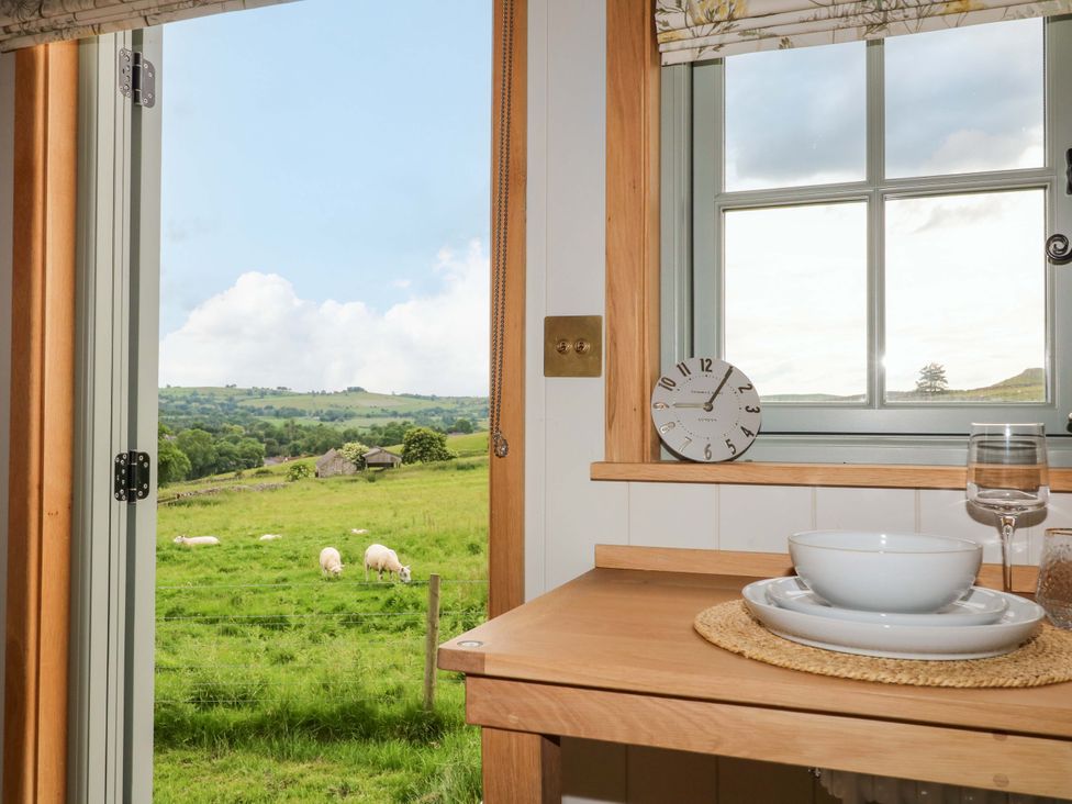 A kitchen with a view of nature at Pike House Farm Shepherds Hut 1 Asbourne