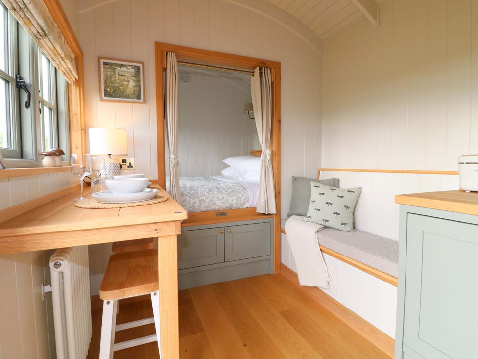 An interior space with a bed and a kitchenette at Pike House Farm Shepherds Hut 1 Asbourne