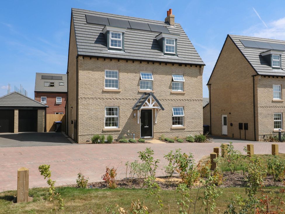 A house with a garage and plants at No.6 Beck Crescent in Ashbourne