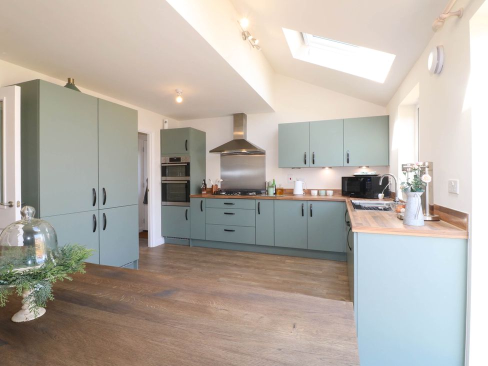 A kitchen with cabinets and appliances at No.6 Beck Crescent in Ashbourne