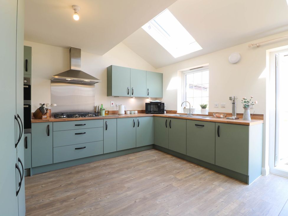A kitchen with cabinets and a sink at No.6 Beck Crescent in Ashbourne