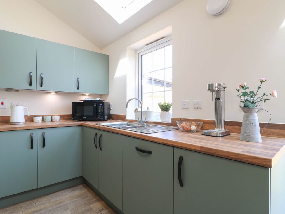 A kitchen with cabinets and appliances at No.6 Beck Crescent Ashbourne