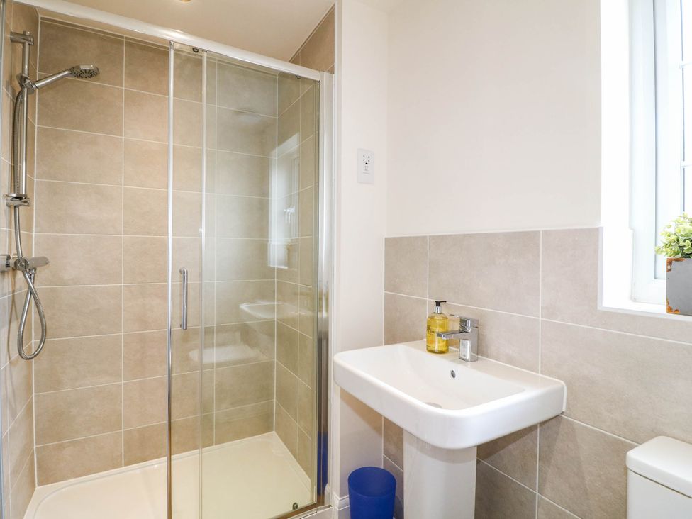 A bathroom with a shower and sink in No.6 Beck Crescent Ashbourne