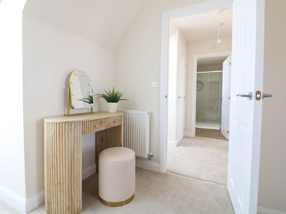 A dressing room with a vanity table and mirror at No.6 Beck Crescent in Ashbourne