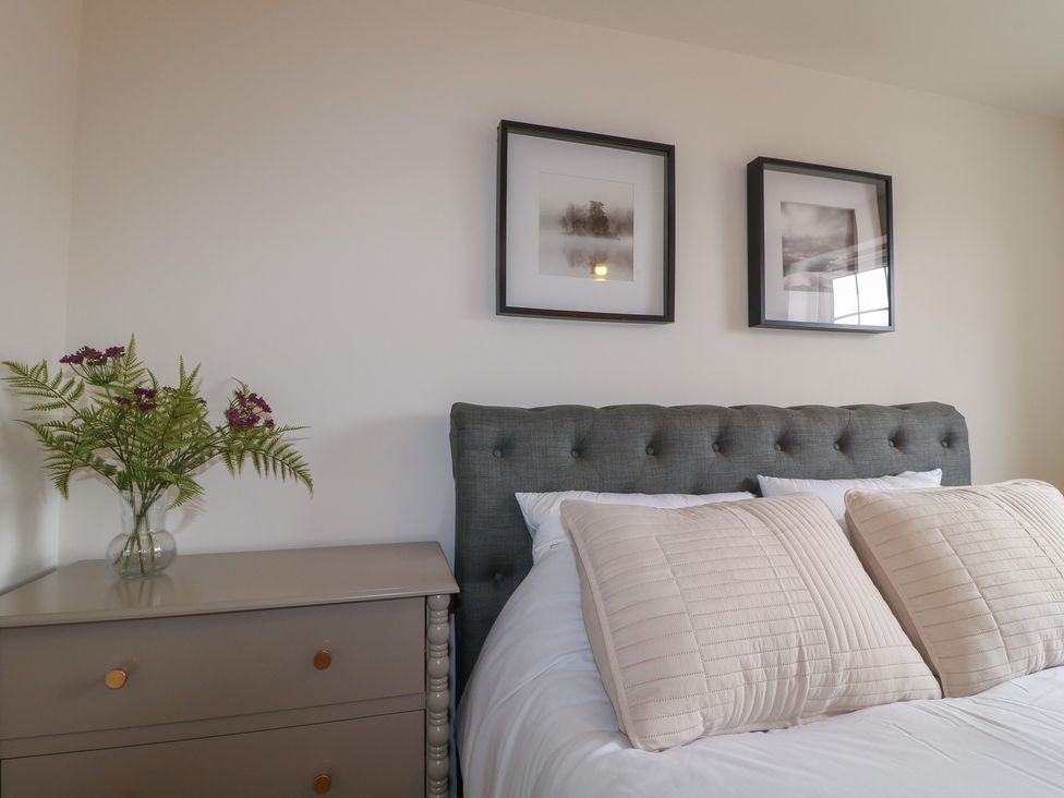 A bedroom with a bed and bedside table at No.6 Beck Crescent in Ashbourne