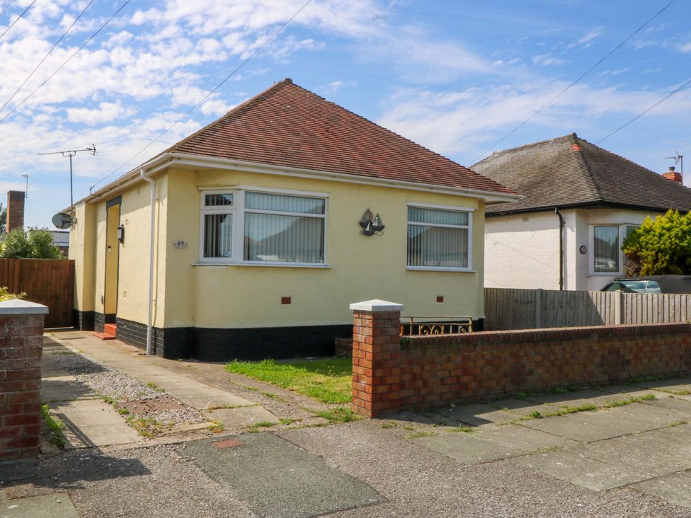 A bungalow with a driveway and pathway at Seaside Bungalow in Rhyl