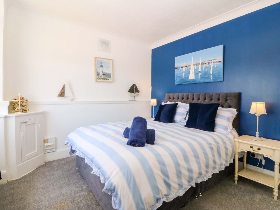 A bedroom with a bed and nightstand at Seaside Bungalow in Rhyl