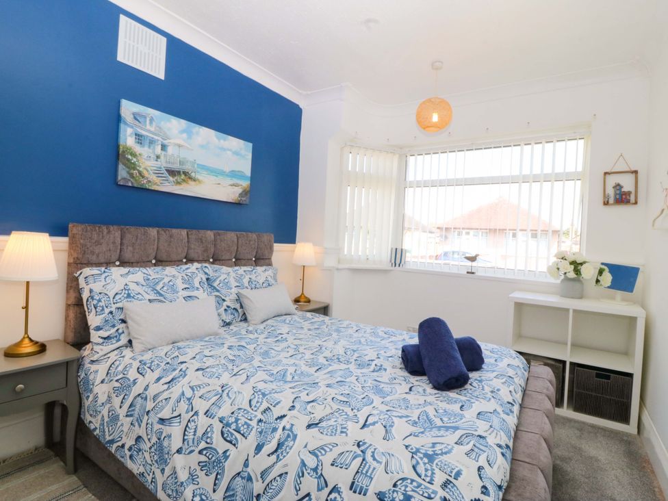 A bedroom with a bed and lamps at Seaside Bungalow in Rhyl