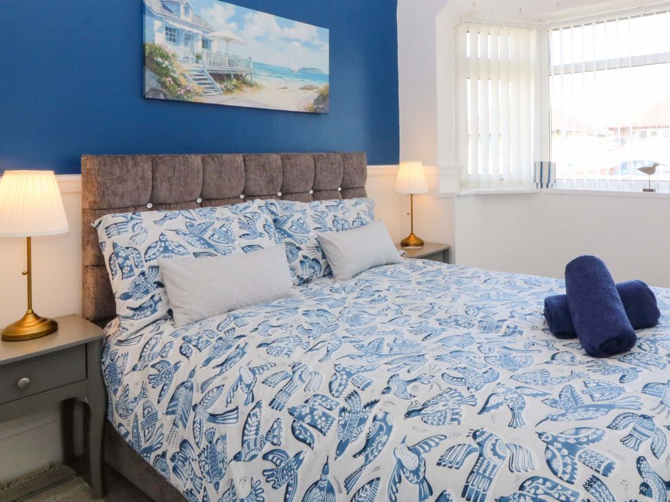 A bedroom with a bed and bedside table at Seaside Bungalow in Rhyl