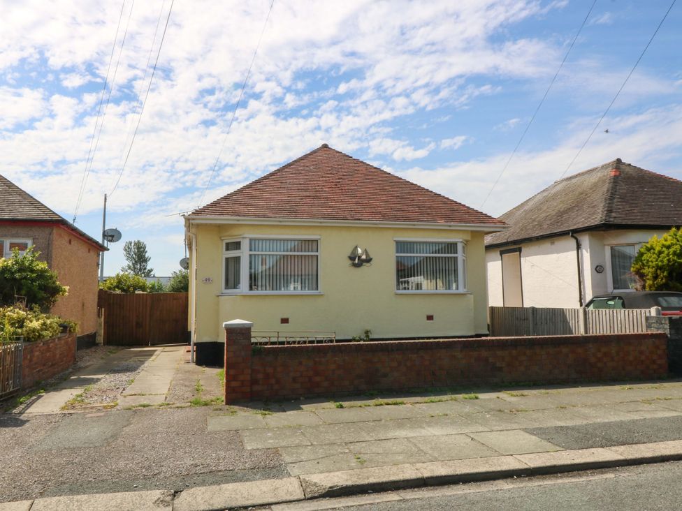 A bungalow with a driveway and front yard at Seaside Bungalow Rhyl