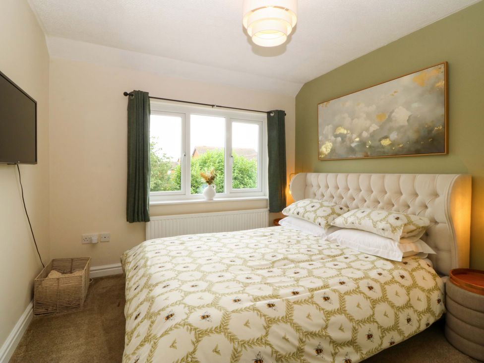 A bedroom with a bed and television at Robins Nest in Rhyl