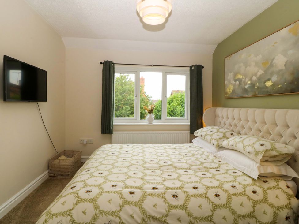 A bedroom with a bed and television at Robins Nest in Rhyl