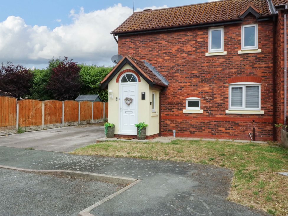 A house with a front door and garden at Robins Nest in Rhyl
