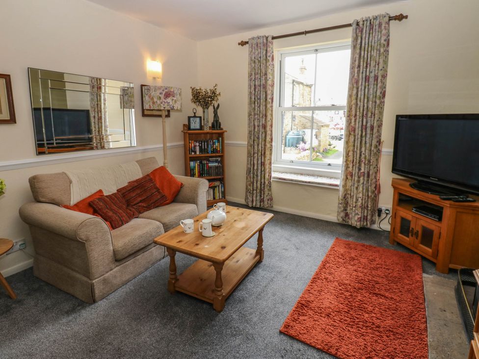 A living room with a sofa and coffee table at Kernot Cottage in Reeth