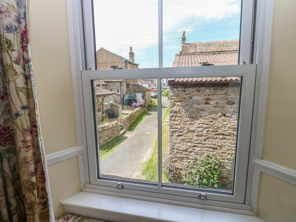 A view from a window showing buildings and a street at Kernot Cottage in Reeth