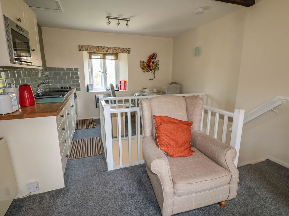 A kitchen with a stove and kettle at Kernot Cottage in Reeth