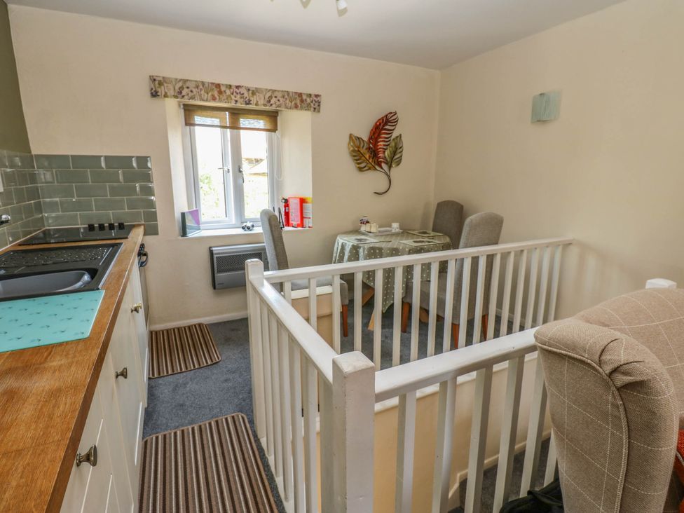 A dining room with a table and chairs at Kernot Cottage in Reeth