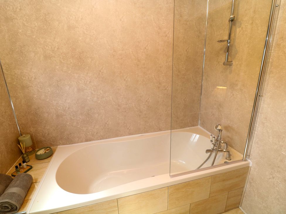 A bathroom with a bath tub and shower at Moorhen Lodge in Market Rasen