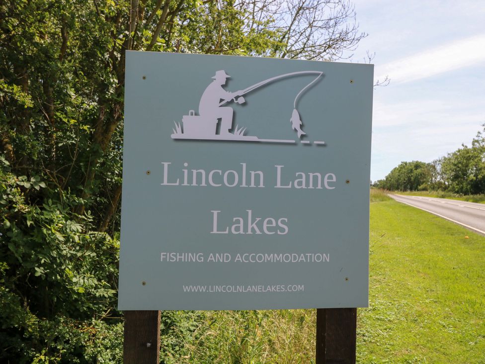 A sign for Lincoln Lane Lakes near a road in Market Rasen
