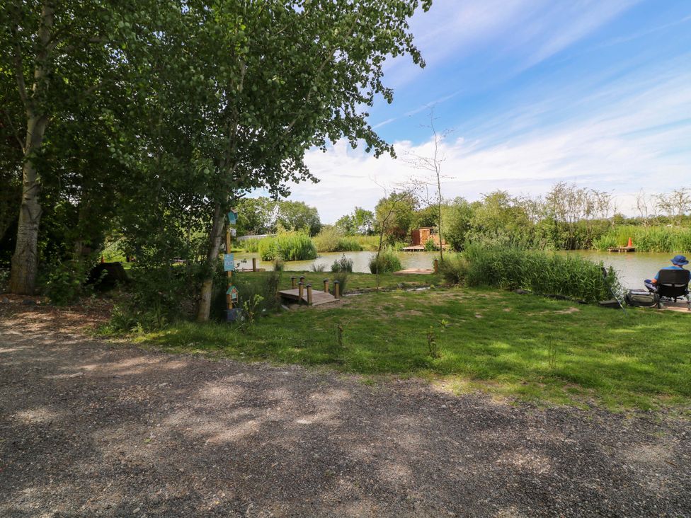An outdoor area with a view of water and greenery at Moorhen Lodge in Market Rasen