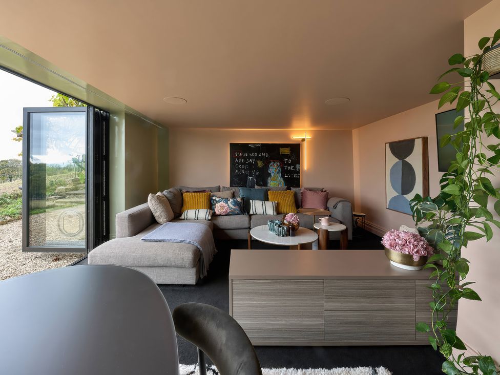 A snug with a sofa and coffee table at Providence Cottage Trellech