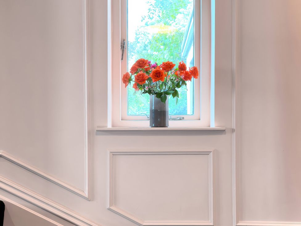 A window with flowers in a vase at Providence Cottage Trellech