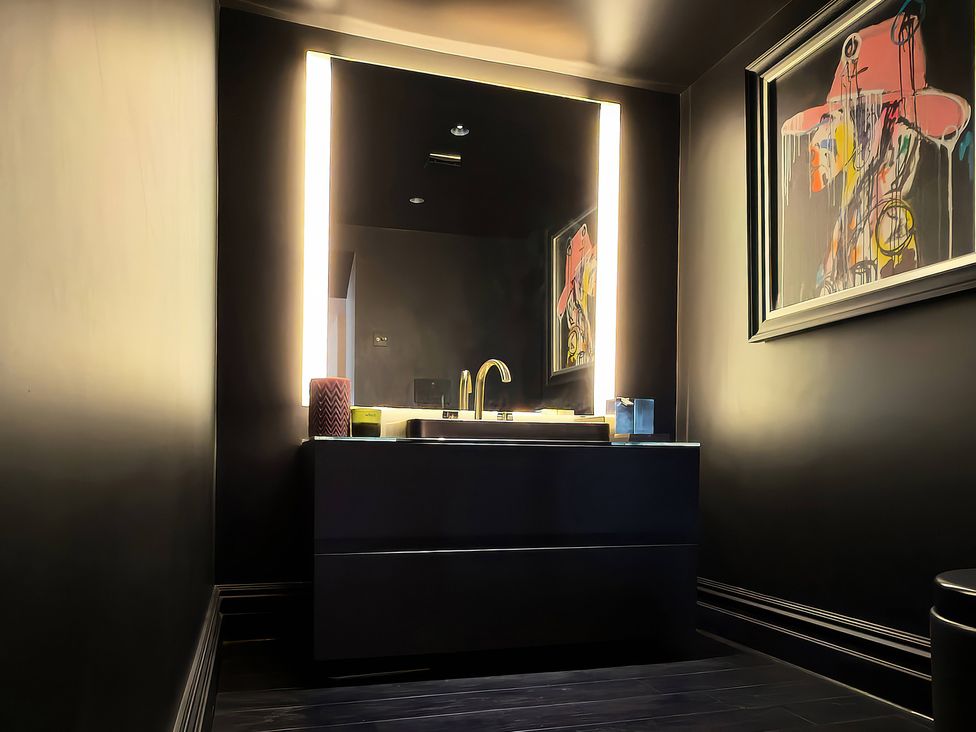 A bathroom with a sink and mirror at Providence Cottage in Trellech