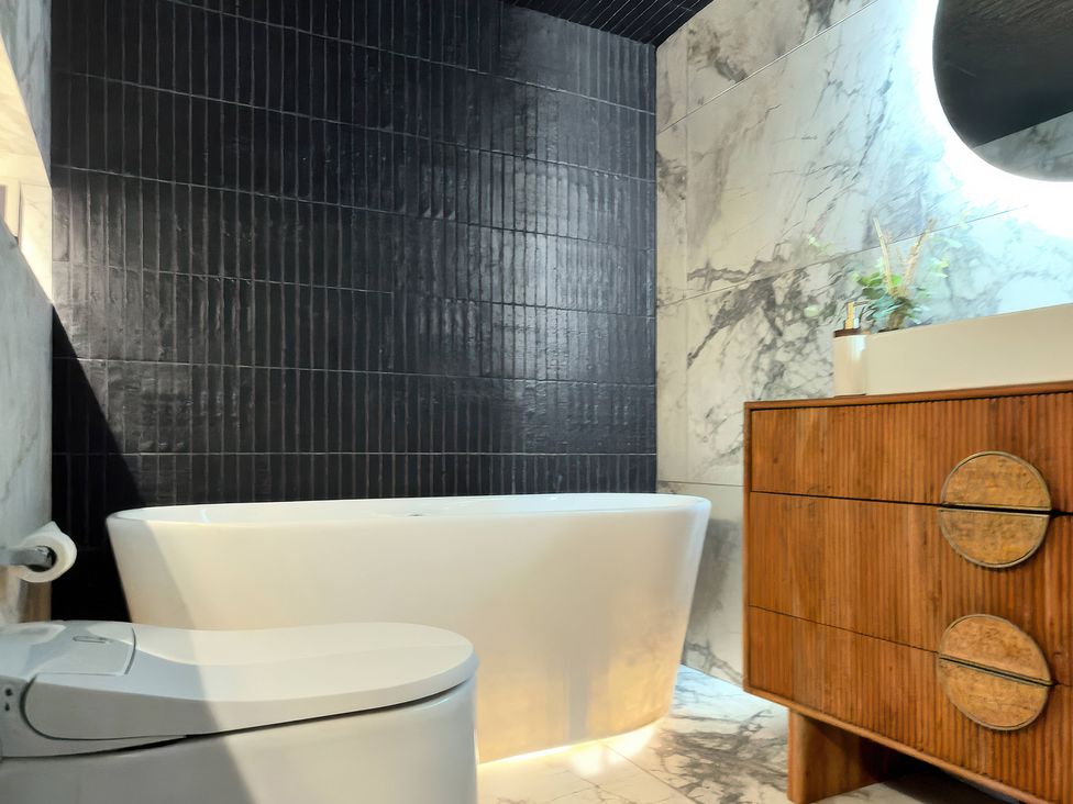 A bathroom with a bathtub, toilet, and vanity at Providence Cottage Trellech