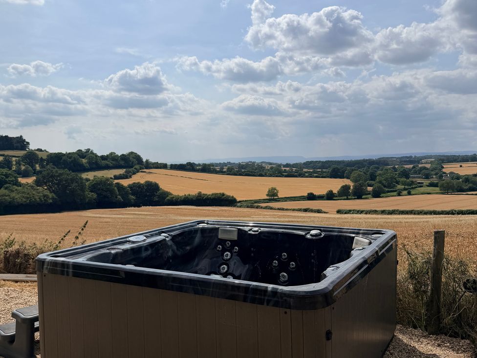 A hot tub overlooking fields at Providence Cottage Trellech