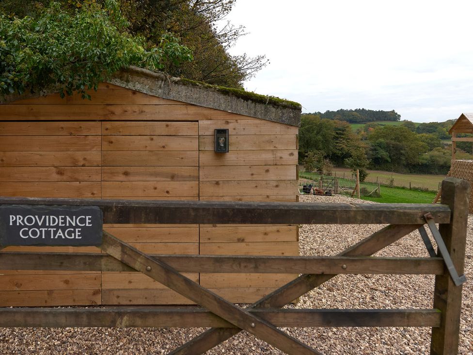 A wooden gate with a sign at Providence Cottage Trellech