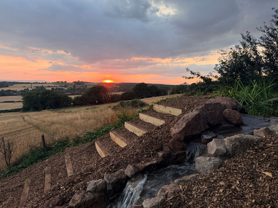 A landscape with stairs and a water feature at Providence Cottage in Trellech