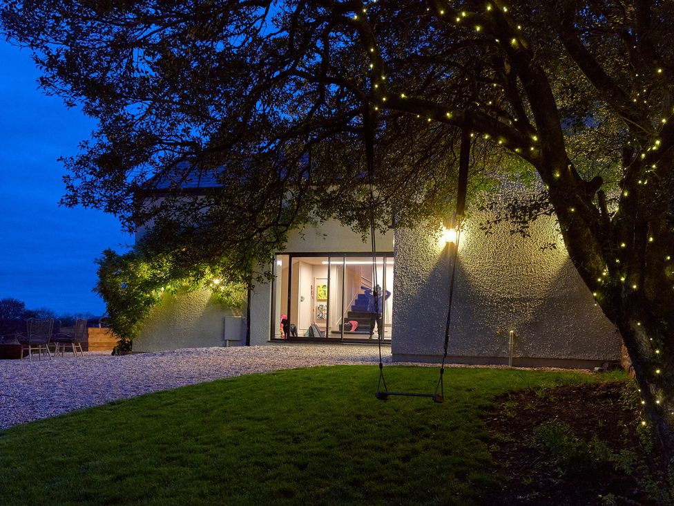 An outdoor area with a house and tree lights at Providence Cottage Trellech