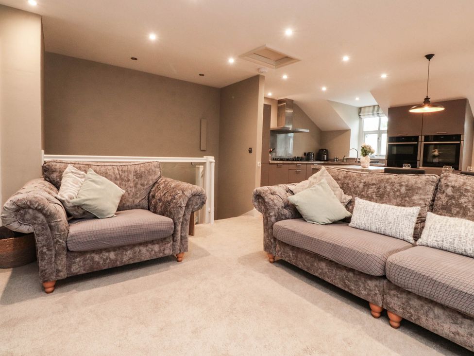 A living room with sofas and an open kitchen at 4 Church Hall Mews Garstang