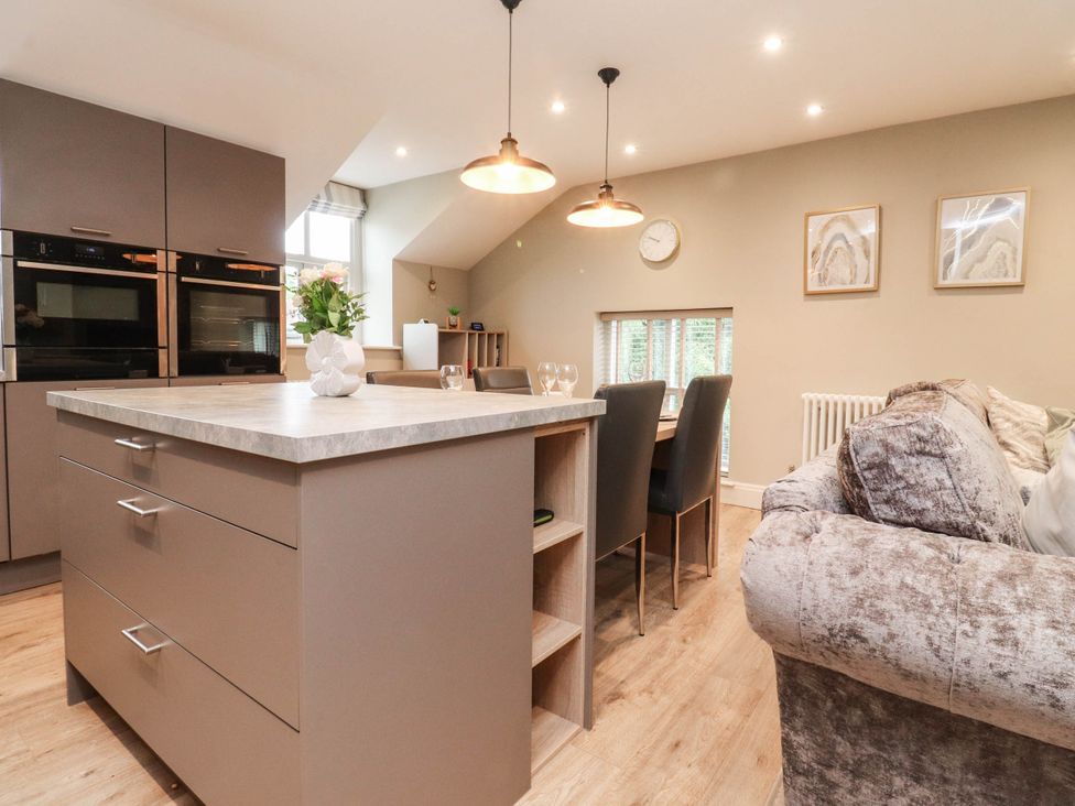 A kitchen with an island and dining area at 4 Church Hall Mews in Garstang
