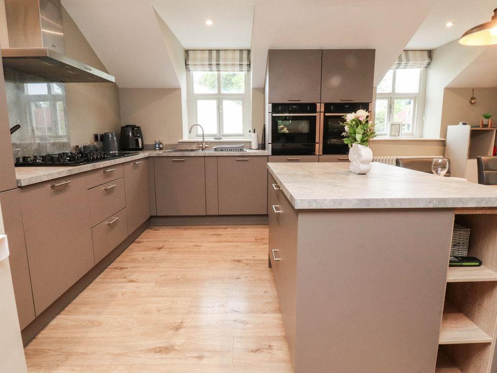 A kitchen with cabinets and appliances at 4 Church Hall Mews Garstang