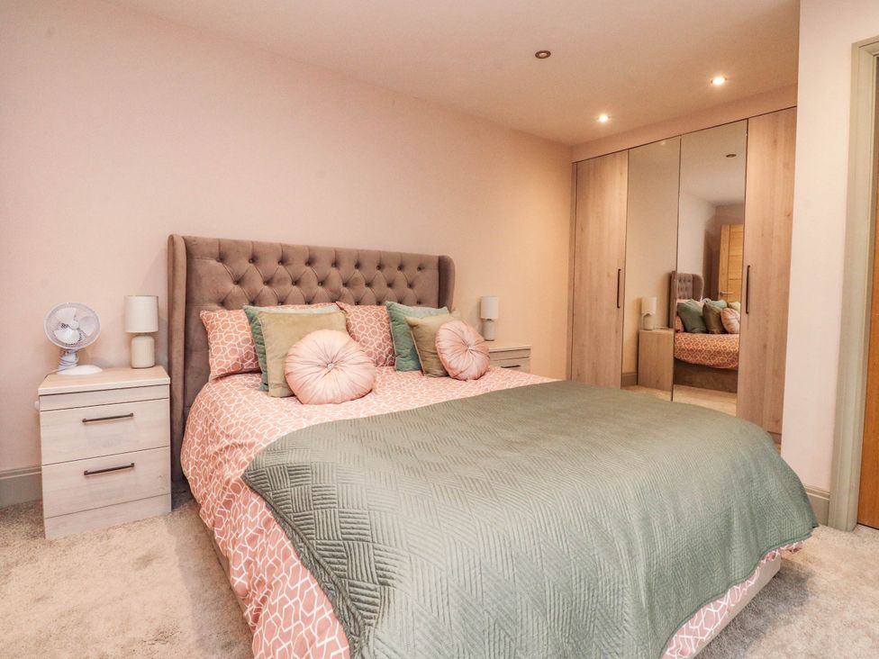 A bedroom with a bed and wardrobe at 4 Church Hall Mews in Garstang